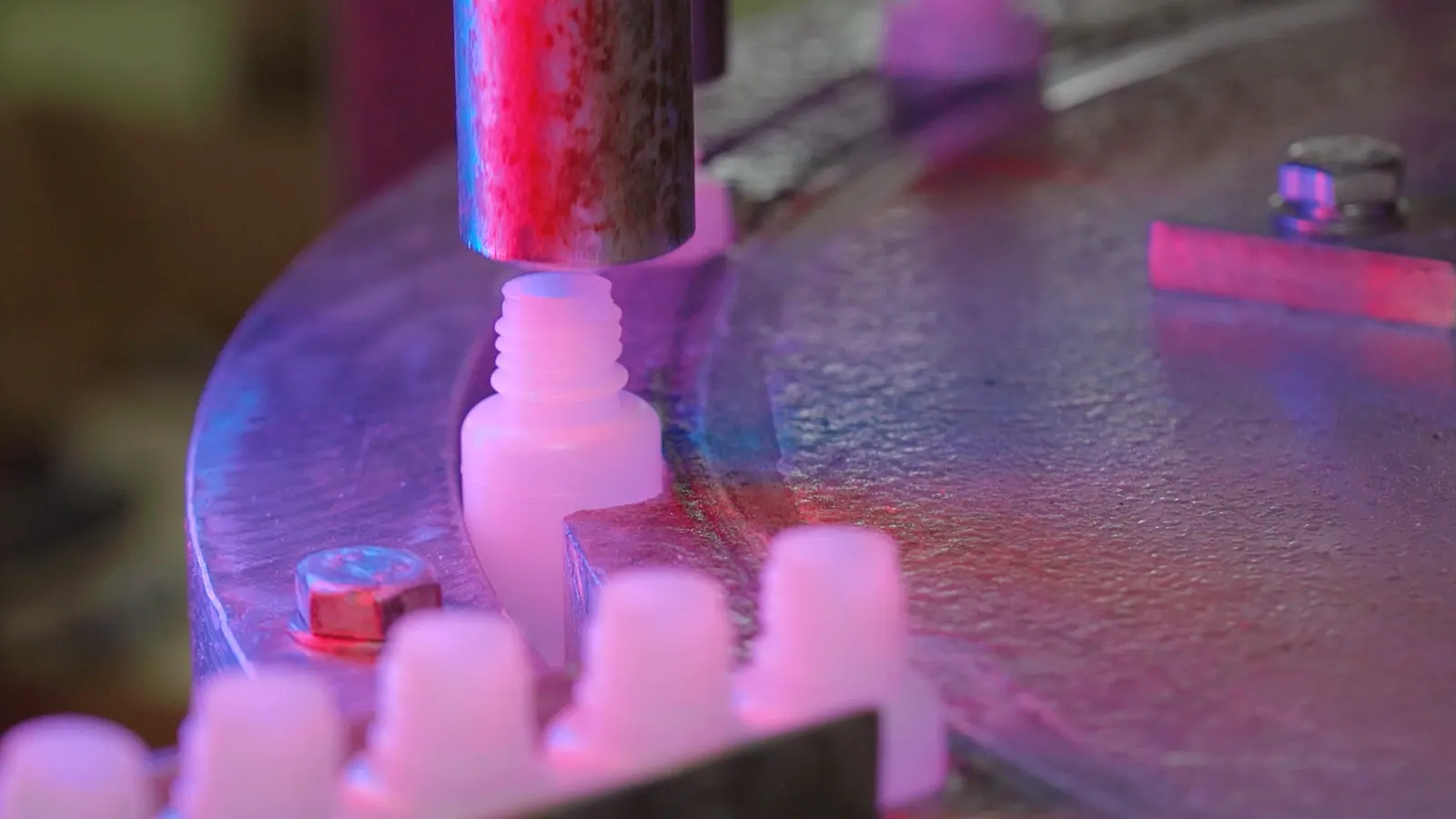 Automated filling line dispensing cyanoacrylate