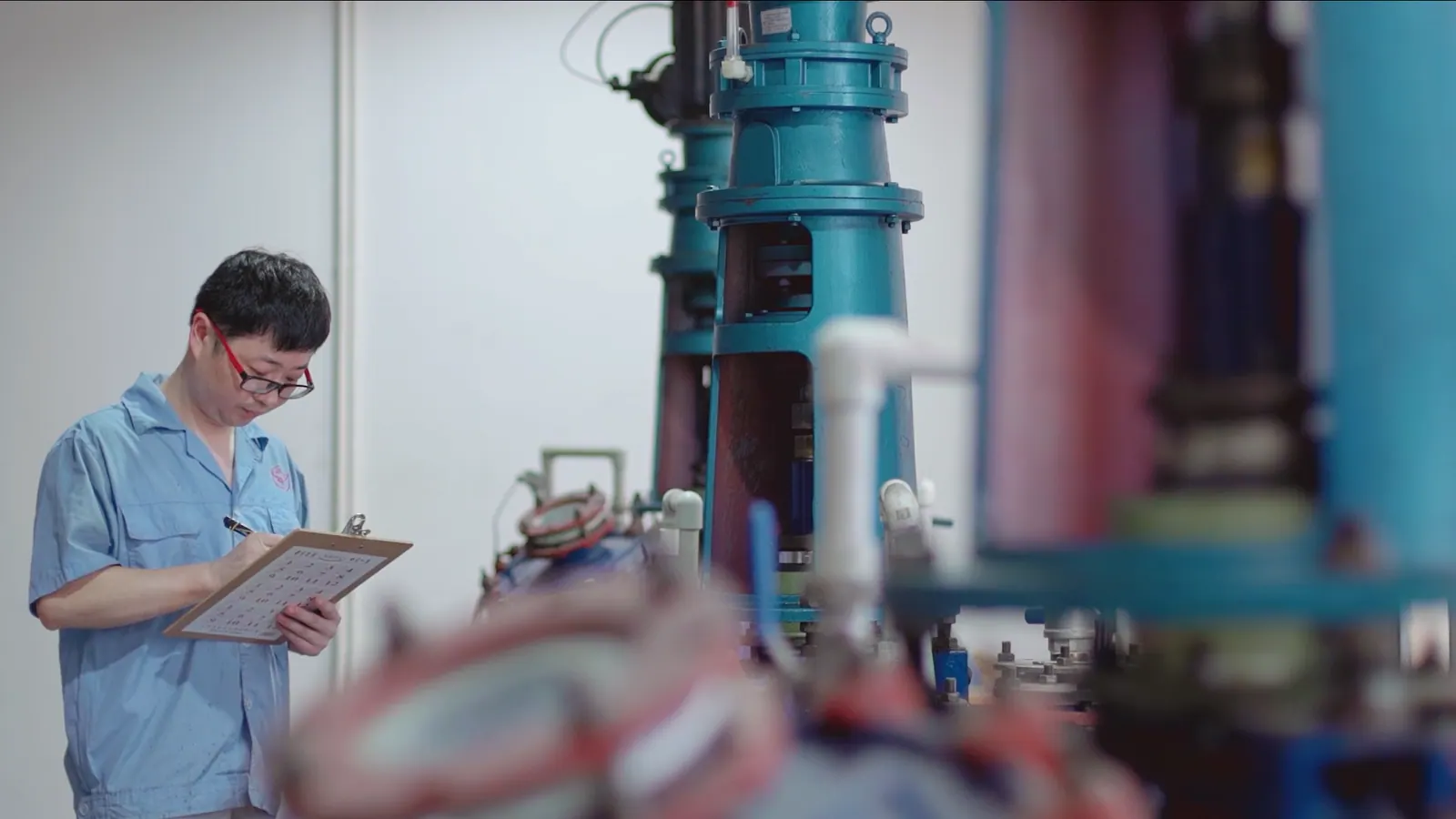 Quality technician inspecting cyanoacrylate bonds on industrial parts